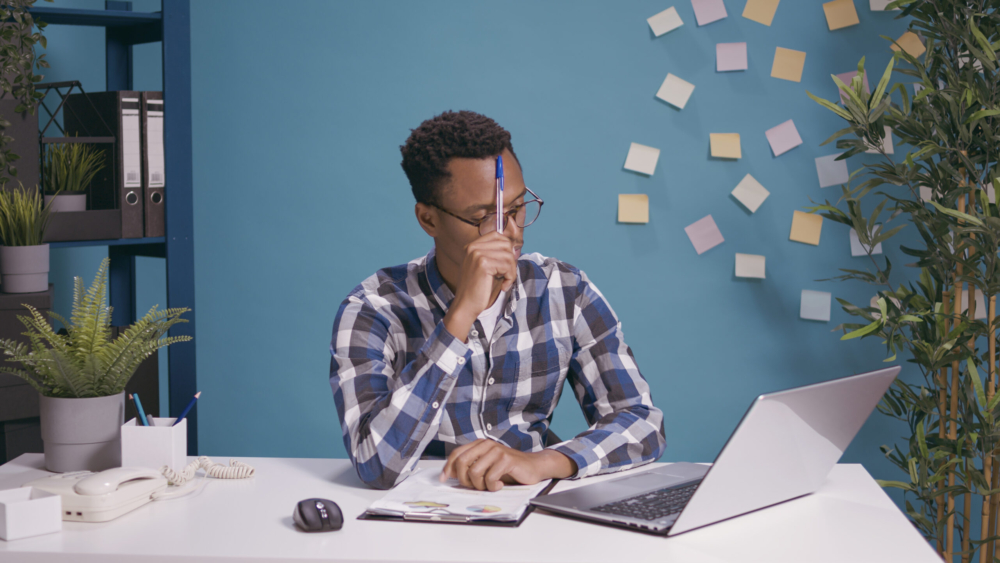 Thoughtful employee brainstorming ideas to plan business strategy, contemplation concept. Pensive worker thinking about successful solution, using creative imagination for growth.