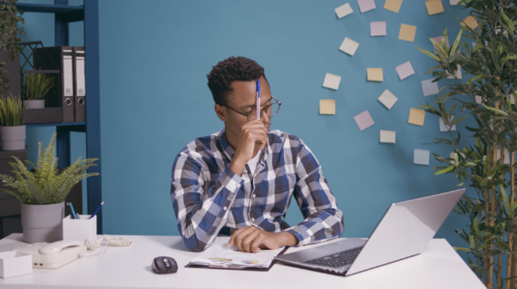 Thoughtful employee brainstorming ideas to plan business strategy, contemplation concept. Pensive worker thinking about successful solution, using creative imagination for growth.